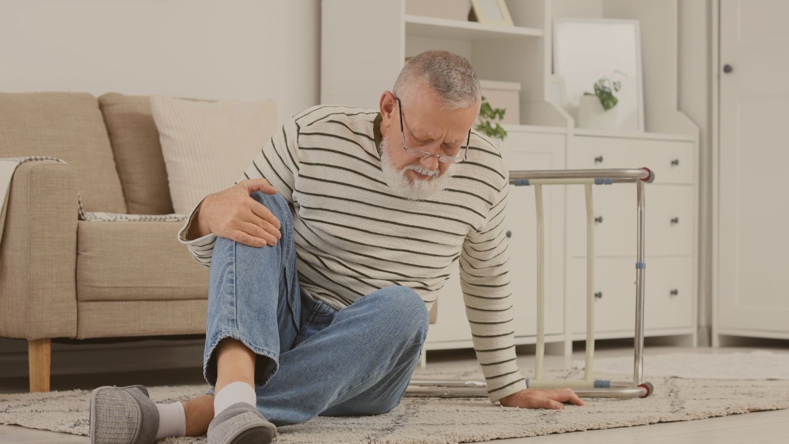 Older adult practicing fall prevention exercises at home while sitting on the floor.